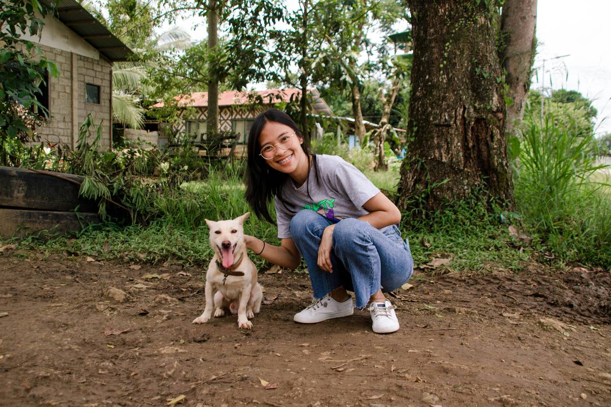A happy owner embracing her dog after being reunited post-tornado
